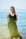 Woman in a Double Gauze Cotton Maxi Slip Dress standing on a beach with clear blue water and sky.