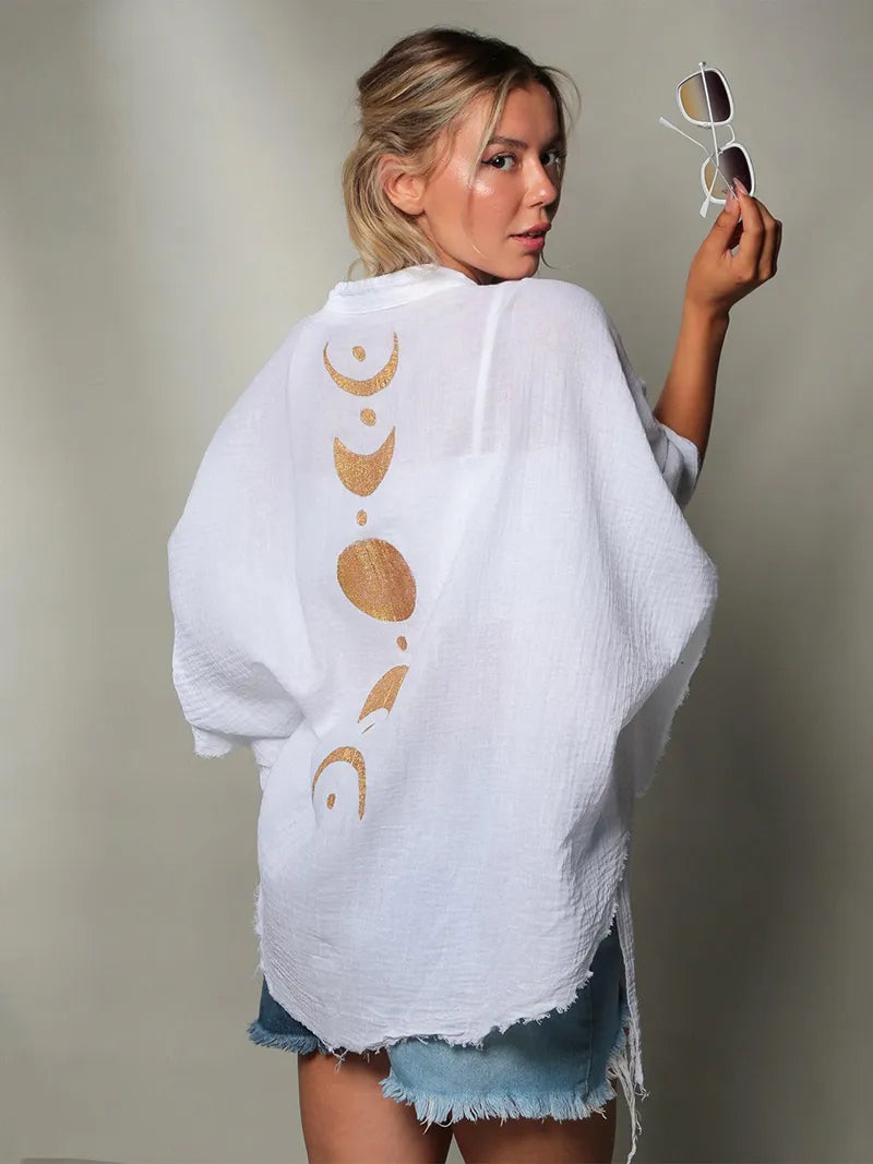 Bride-to-be in a white cotton gauze robe with golden moon phases — a soft bridal getting-ready robe