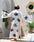 Woman in a white evil eye kimono robe with blue eye prints outdoors #Color_White/Blue_Eye