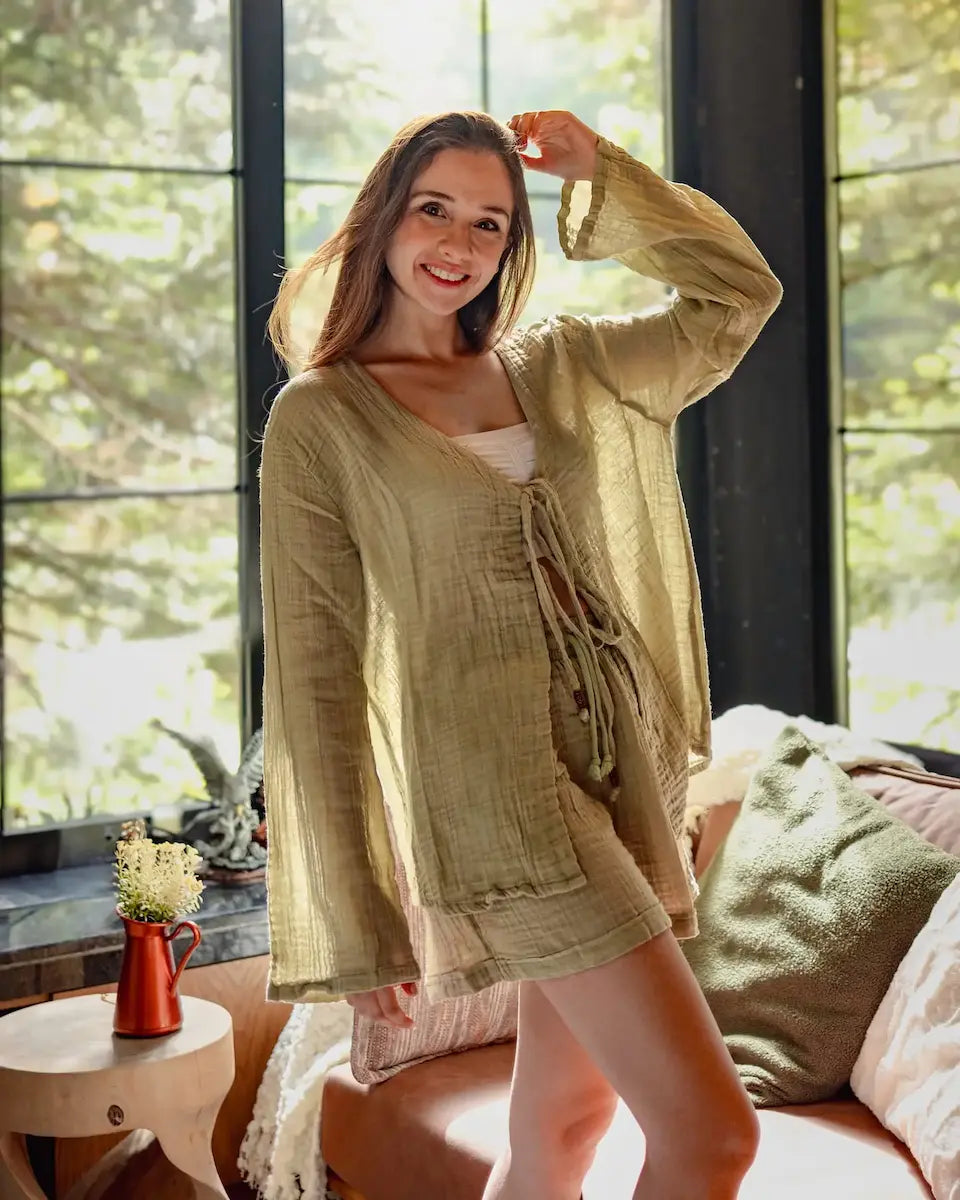 Woman wearing a  muslin loungewear  in a bright room with large windows.