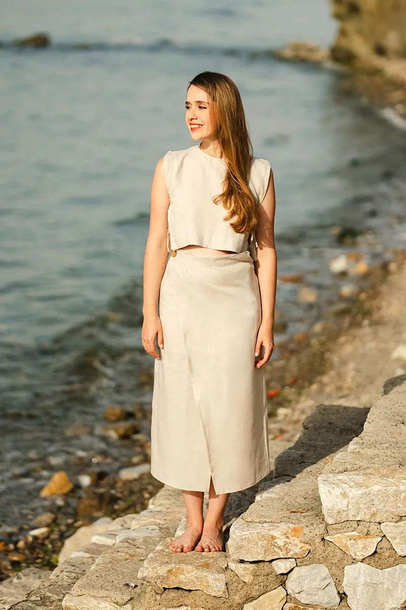 Woman in a beige Linen Wrap Midi Skirt standing by a body of water