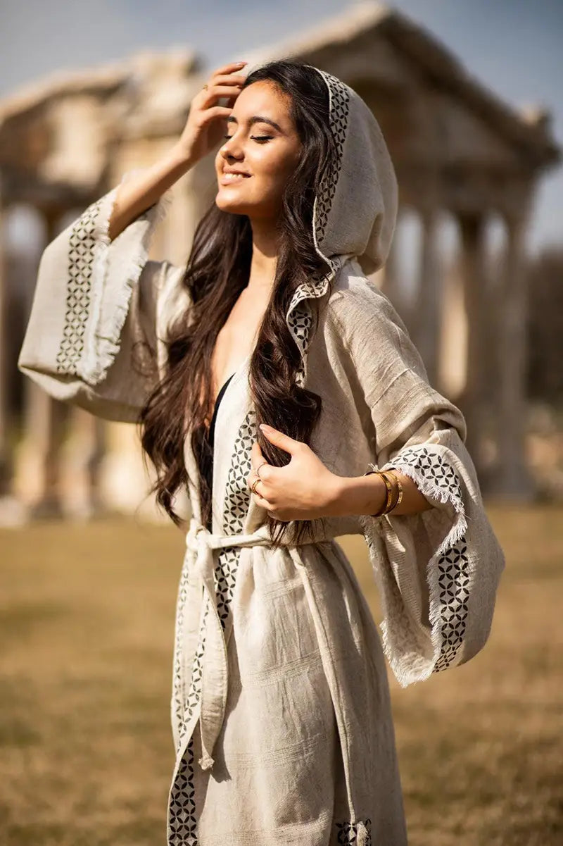 Woman in a linen kimono standing in front of classical architecture