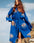 Woman in a blue evil eye kimono with eye prints against a natural background #Color_Blue_Evil_Eye