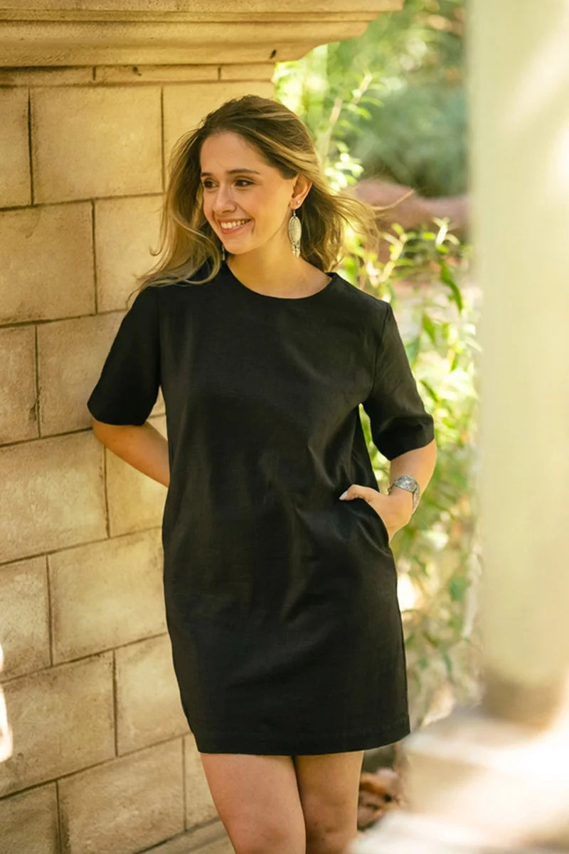 Women wearing a pocket t shirt dress in black with relaxed fit and breathable linen cotton fabric
