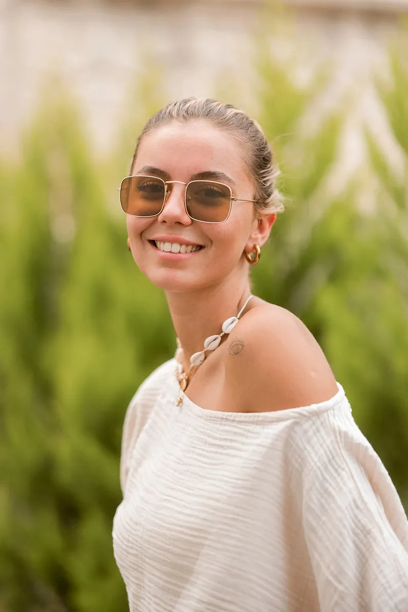 woman wearing beige off the shoulder soft double gauze muslin blouse