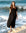 Woman in a Short Sleeve Black Midi dress standing on rocks by the ocean