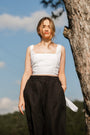 Woman in a white top and black linen palazzo pants by a tree — 100% European Flax linen, wide-leg cut