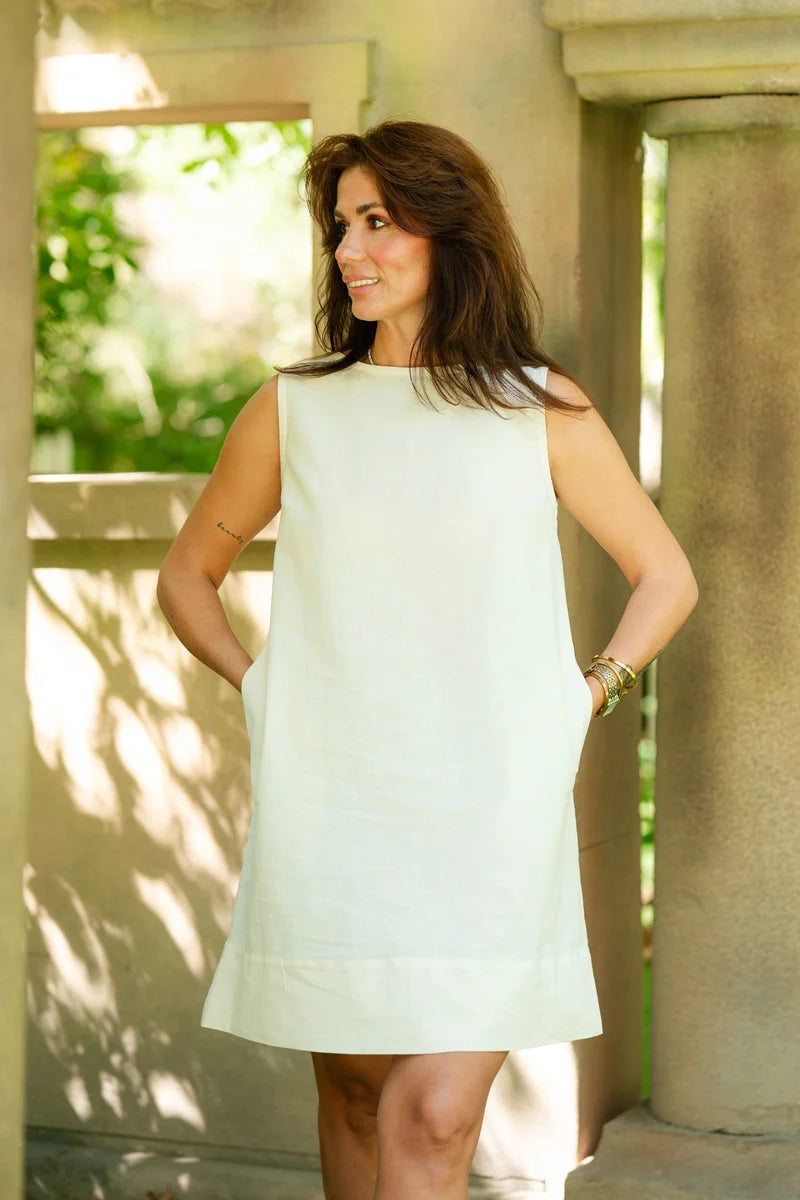 woman posing with off white linen shift dress