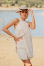 Ivory linen halter vest and shorts set with a hat on a beach — breathable linen two-piece