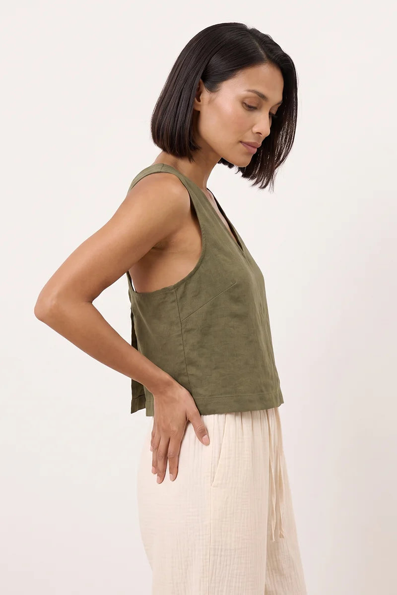Side view of the olive green linen wide strap tank top showing the wide straps and hem band