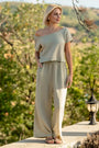 Woman in a green top and green cotton gauze palazzo pants among trees — soft double gauze cotton, wide-leg cut