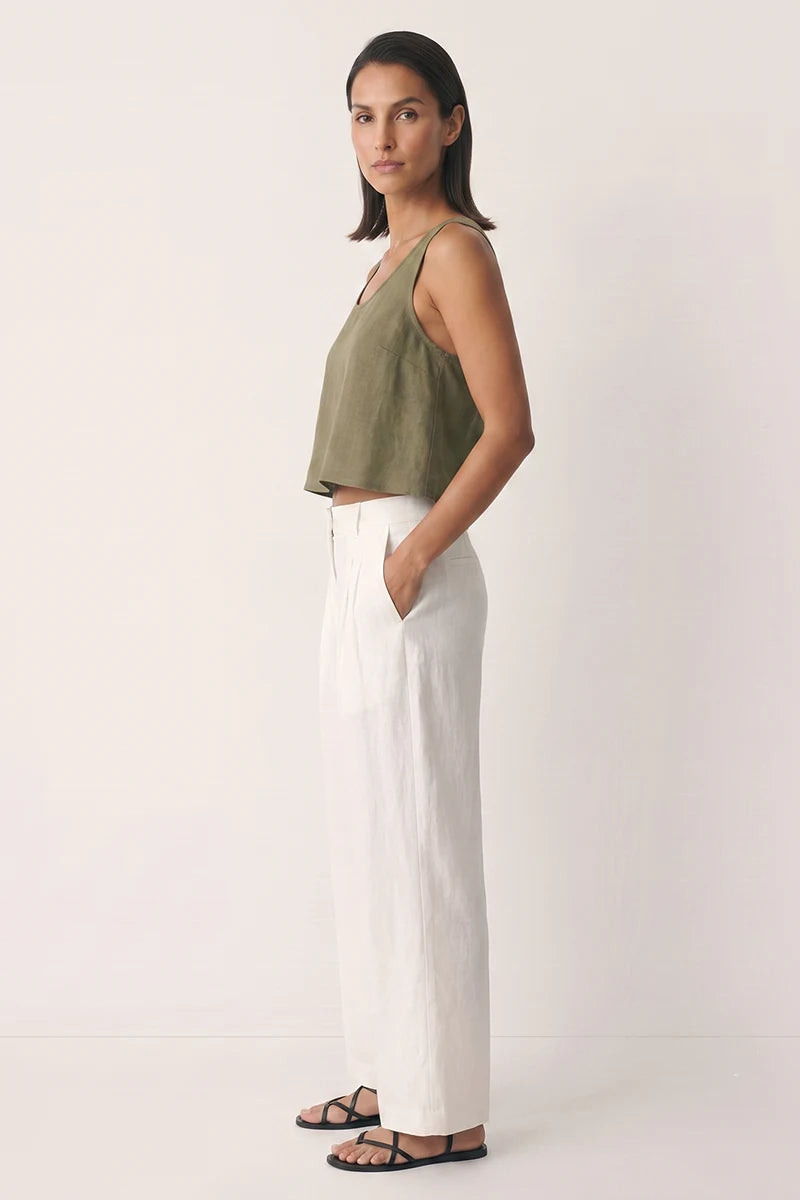 Side view of the olive green cross back tank top showing the relaxed cropped silhouette