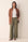 Front view of the olive green linen wide leg pants with a high elastic waist