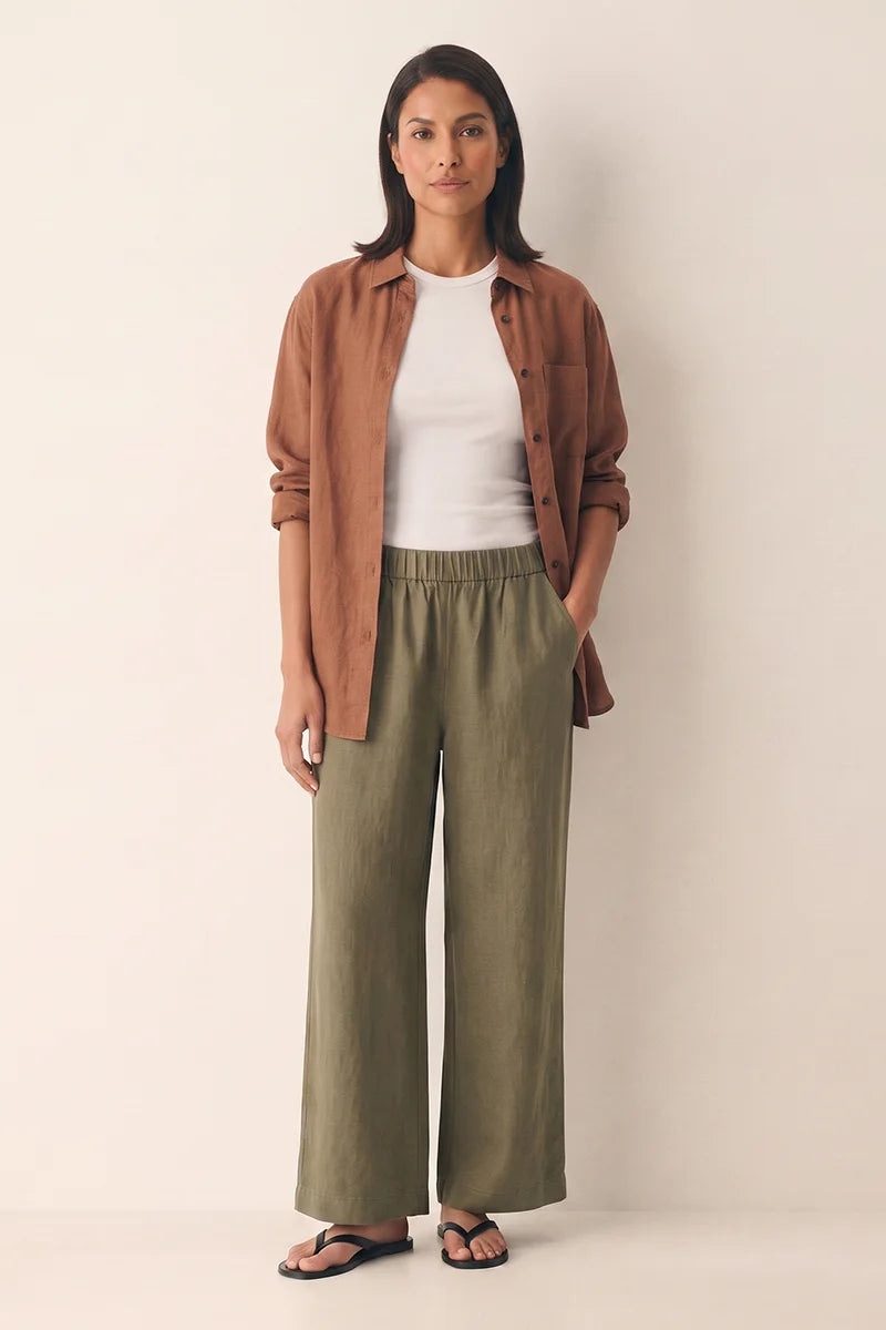 Front view of the olive green linen wide leg pants with a high elastic waist