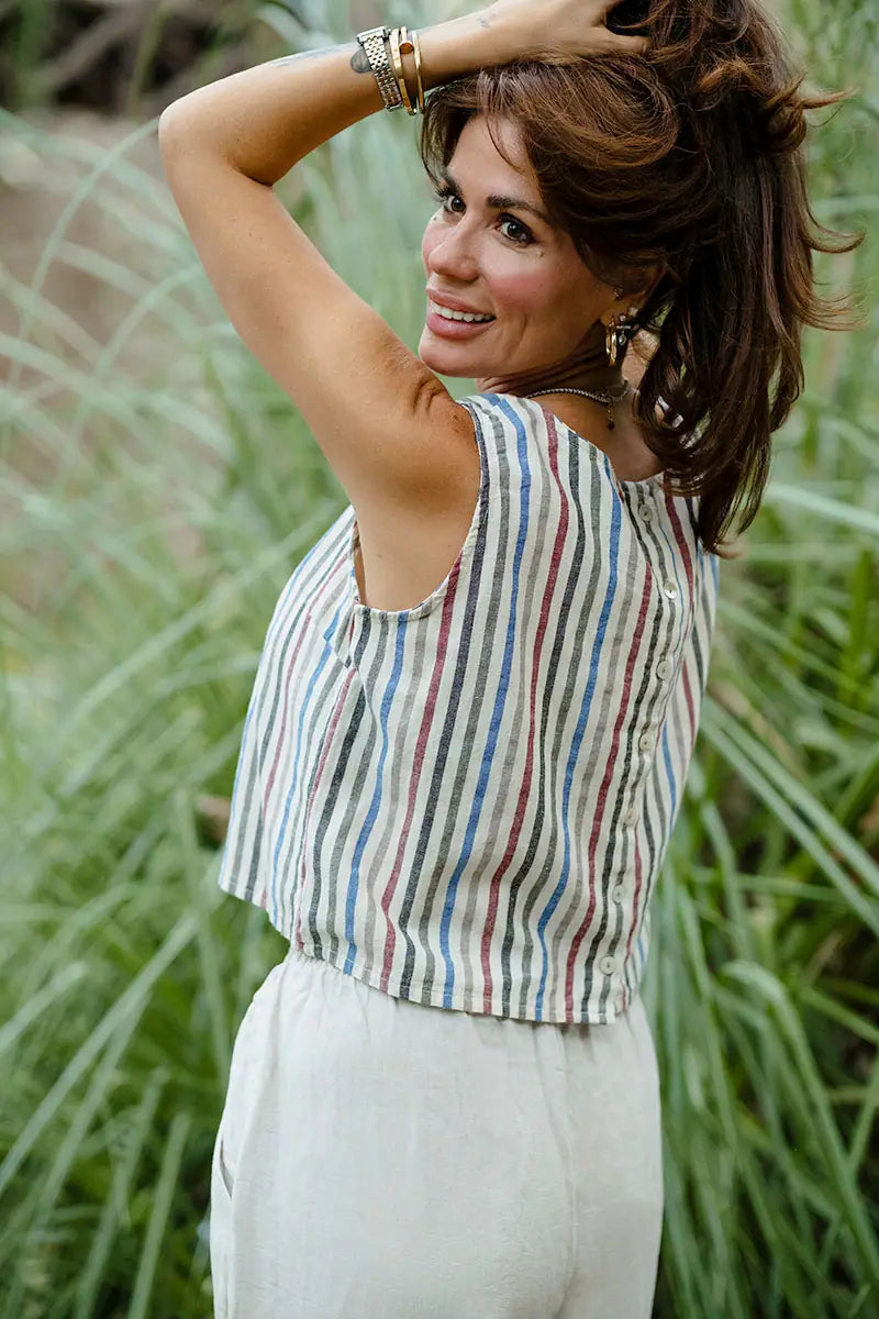 Side view of striped linen shell crop top with sleeveless cut