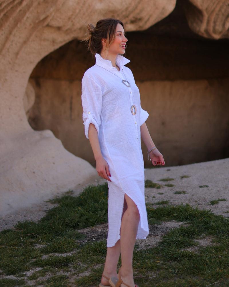 Profile perspective of a white midi dress featuring a slit